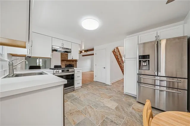 a kitchen with stainless steel appliances a refrigerator stove microwave and sink