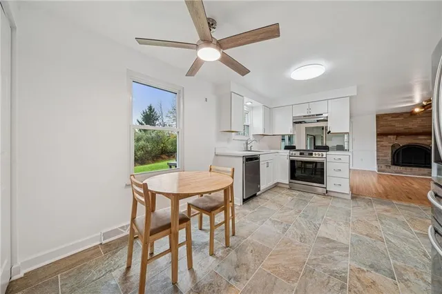a kitchen with a table chairs refrigerator and cabinets