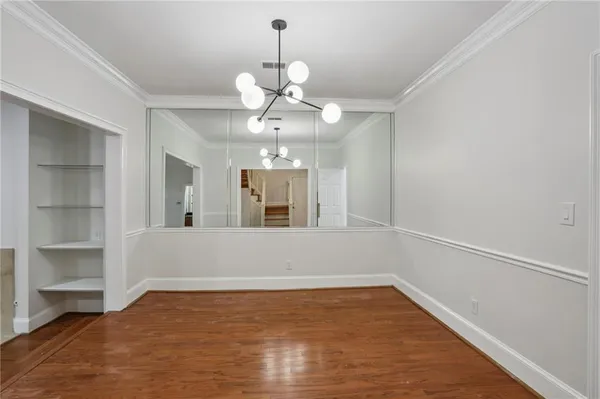 a view of a room with a large window and chandelier