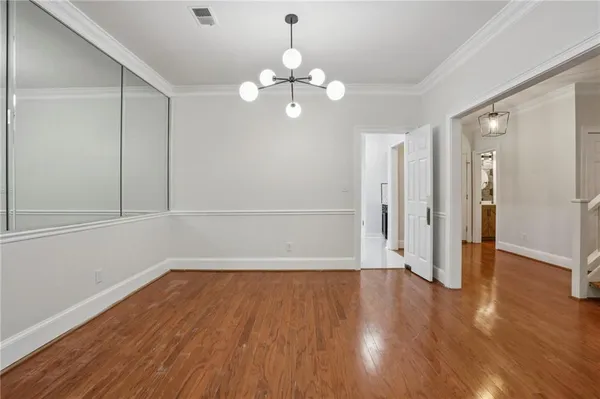 a view of wooden floor and chandelier in a room