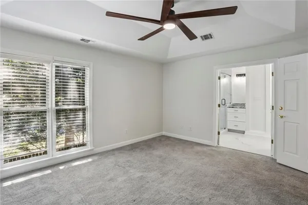 a view of empty room with ceiling fan