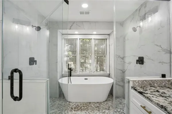 a bathroom with a bathtub and shower