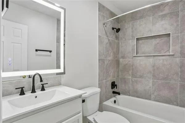 a bathroom with a sink toilet and shower