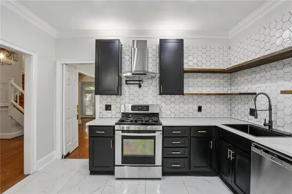 a kitchen with stainless steel appliances granite countertop a stove sink and cabinets
