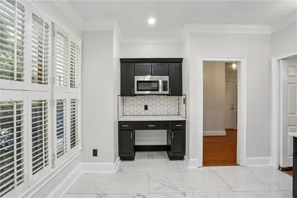 a view of an empty room with a fireplace and a window