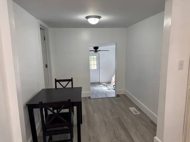 a view of a dining room with furniture and wooden floor