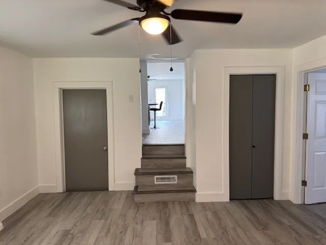 a view of a hallway view with wooden floor and staircase