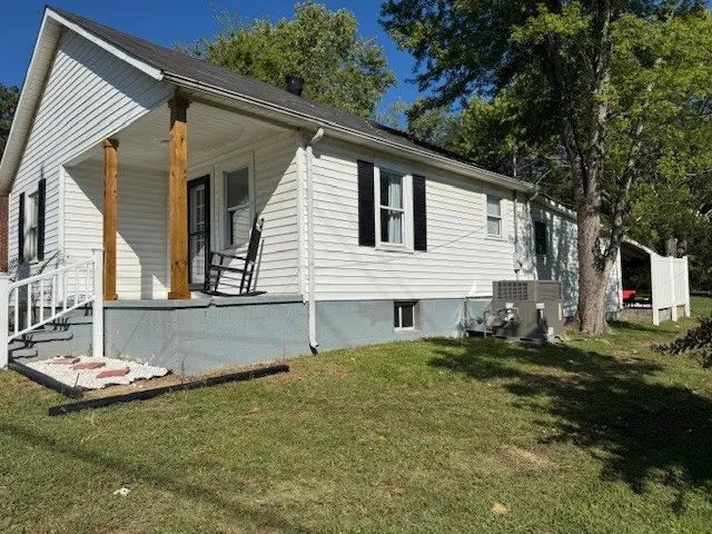 a backyard of a house with table and chairs