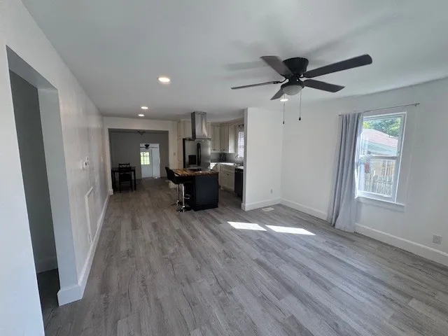 a view of a livingroom with hardwood floor and a ceiling fan