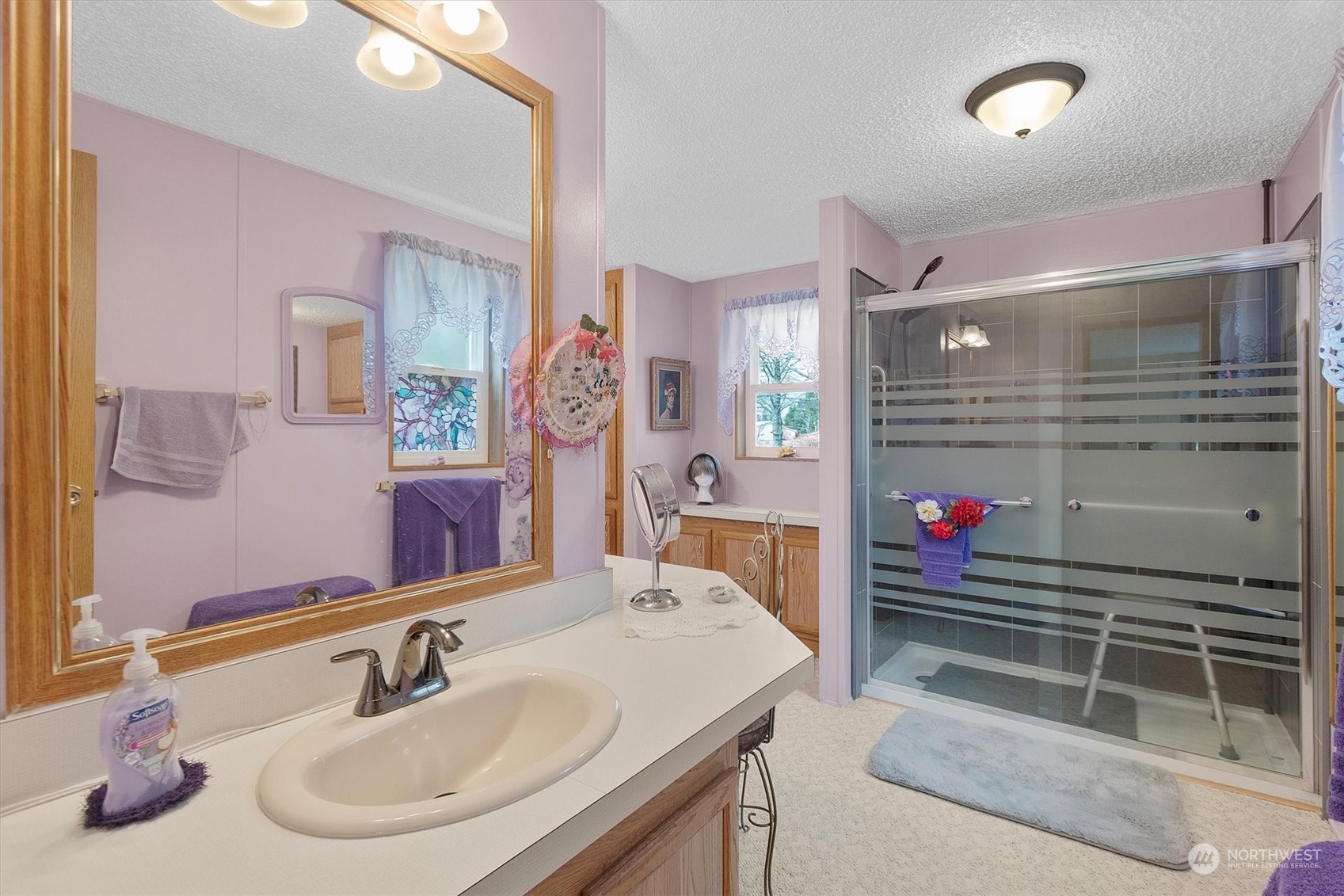 3901 67th Place Long Beach, WA 98631 - Photo 14 of 25 a bathroom with a sink and a mirror