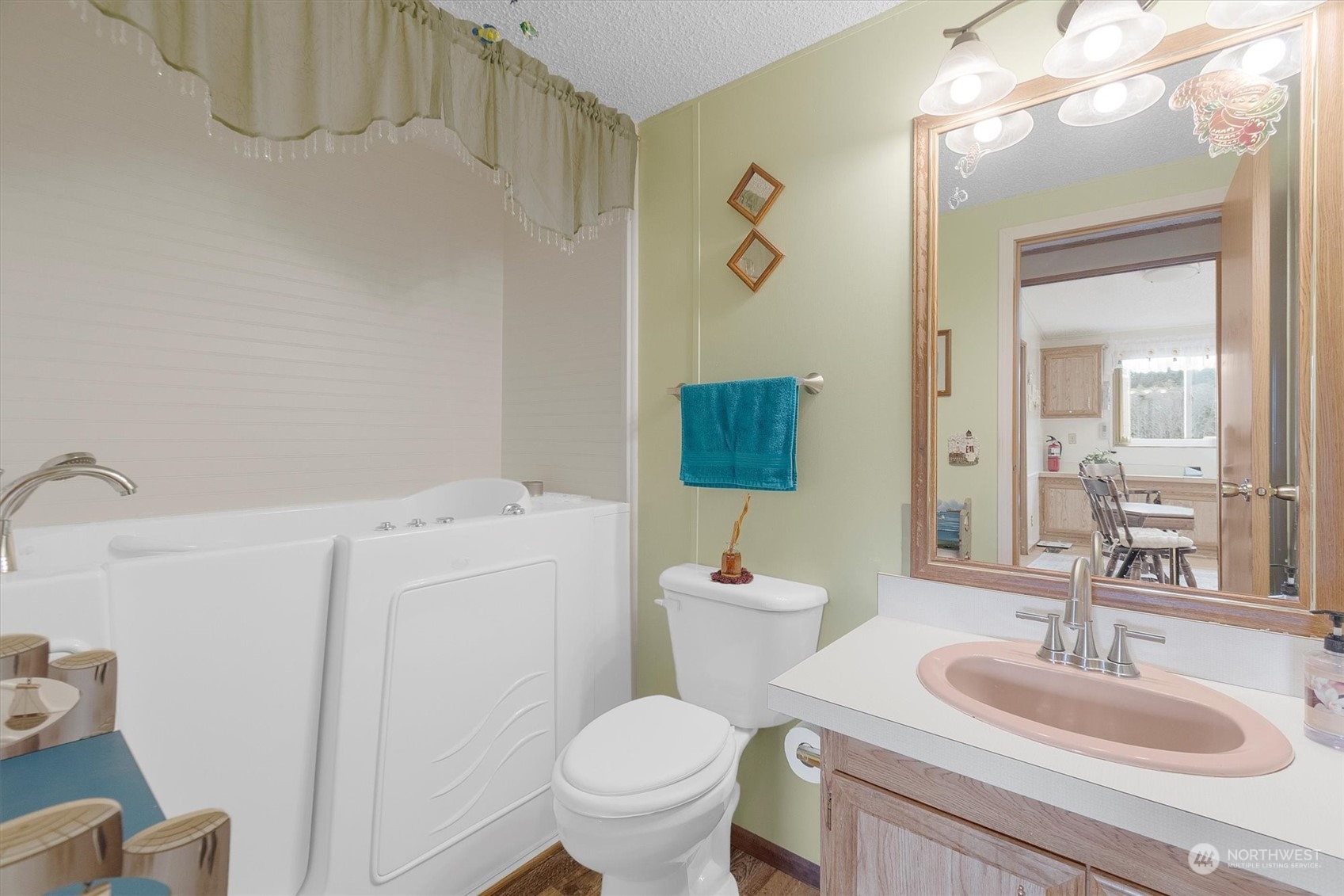 3901 67th Place Long Beach, WA 98631 - Photo 22 of 25 a bathroom with a sink a toilet and a mirror