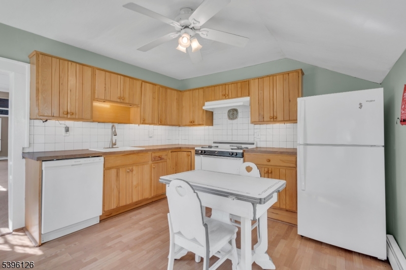 11 Maclennan Place, Unit A Fanwood, NJ 07023 - Photo 14 of 23 a kitchen with a refrigerator a stove a sink and cabinets