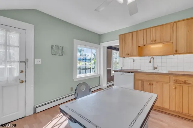 a kitchen with granite countertop a sink a stove and cabinets