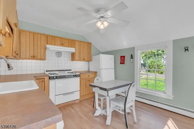 a kitchen with a stove a refrigerator and a sink