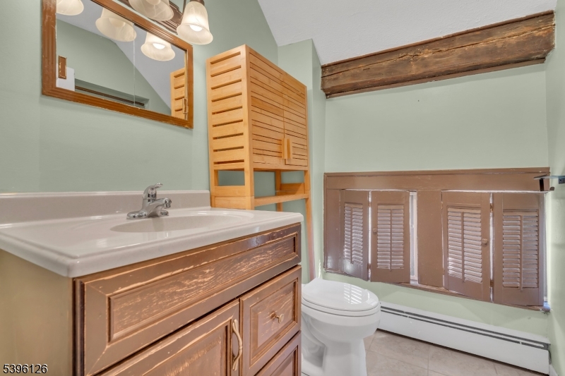 11 Maclennan Place, Unit A Fanwood, NJ 07023 - Photo 20 of 23 a bathroom with a sink a toilet and shower