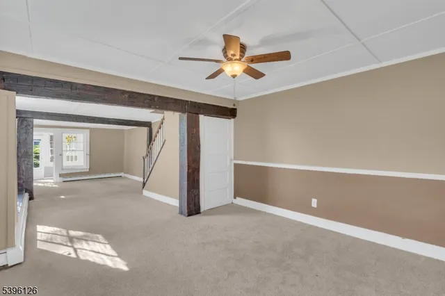 a view of a room with a ceiling fan