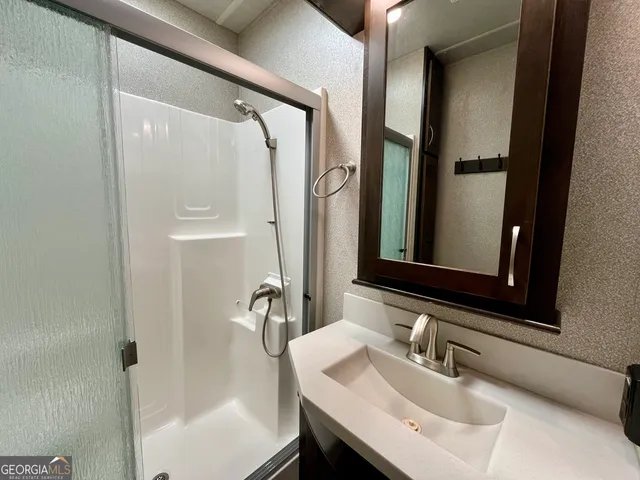 a view of a house with a big yard and sitting area