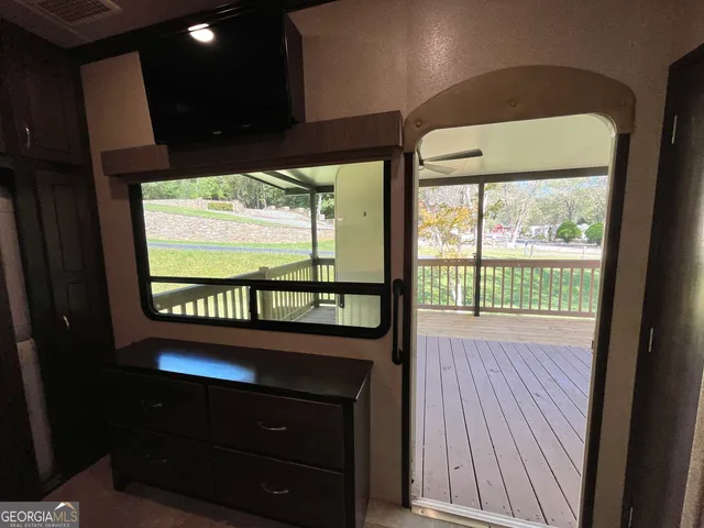 a view of a swimming pool with a patio and a yard