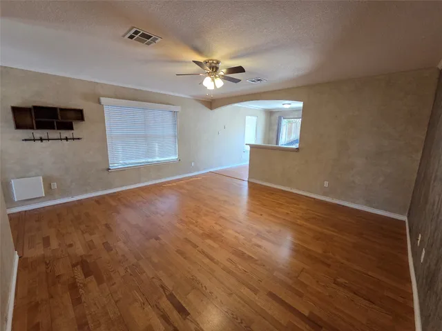 wooden floor in an empty room with a window