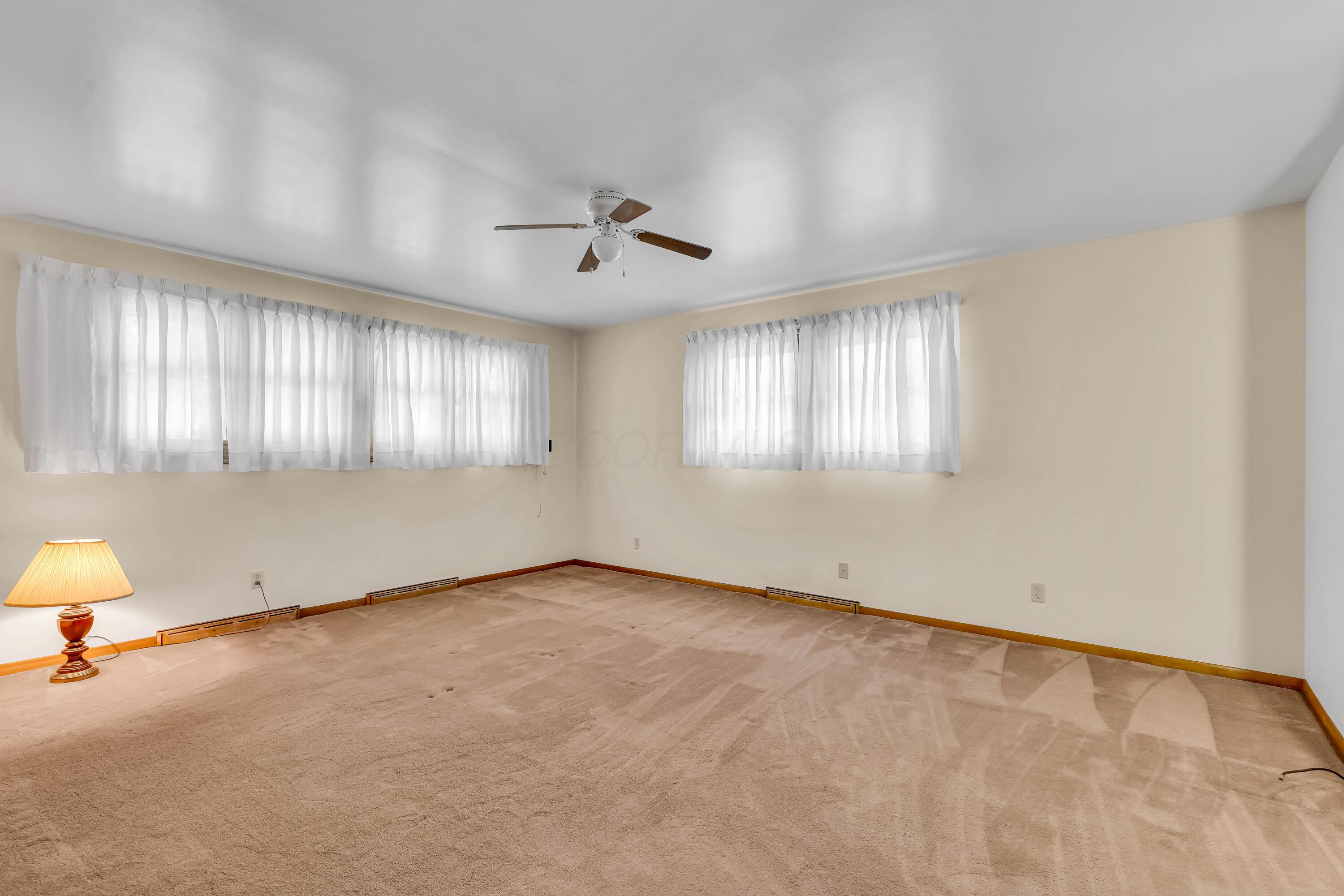 1213 East Cooke Road Columbus, OH 43224 - Photo 32 of 57 • Tan carpet • Hardwood flooring under carpet • Tan painted walls • Lighted ceiling fan • Deep, lighted closet • Built-in desk/vanity