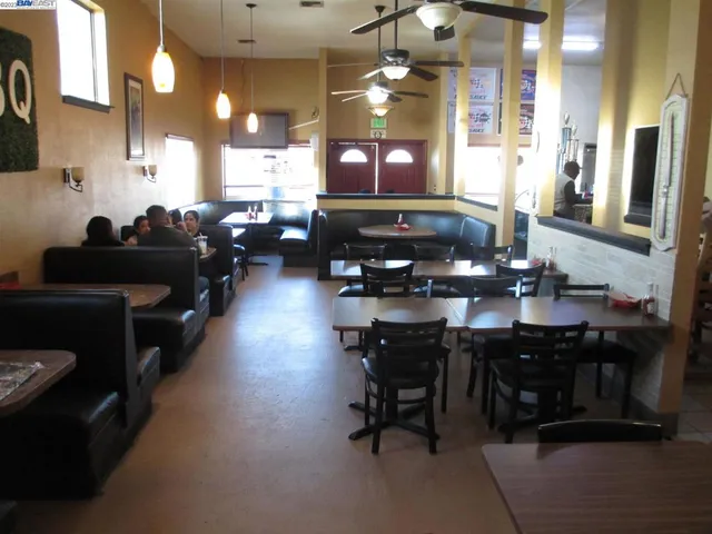 a kitchen with counter space dining table and chairs