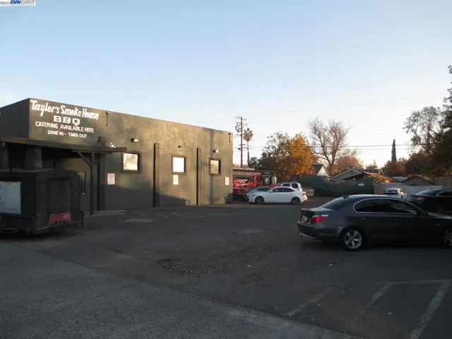 a view of a city street with a cars side of the road