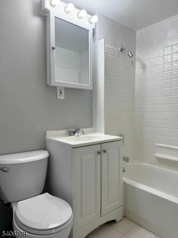 a white toilet sitting next to a bathroom sink