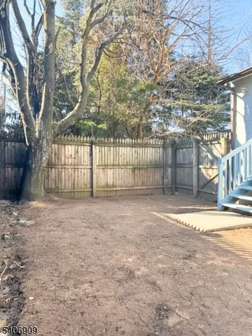 a view of a backyard with large trees