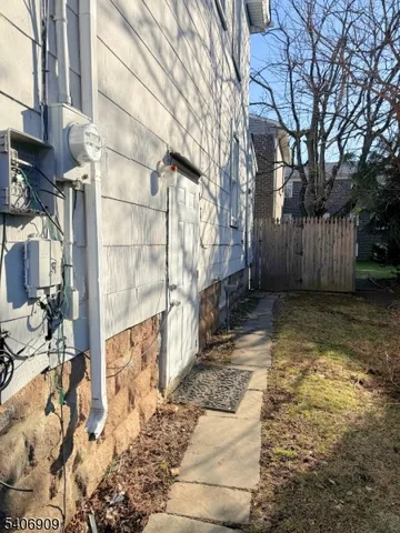 a view of a yard with wooden fence