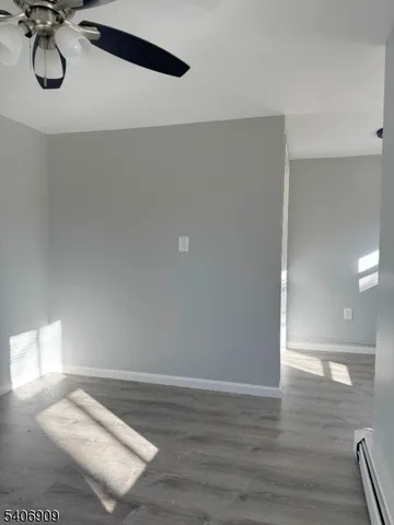 a view of a room with wooden floor