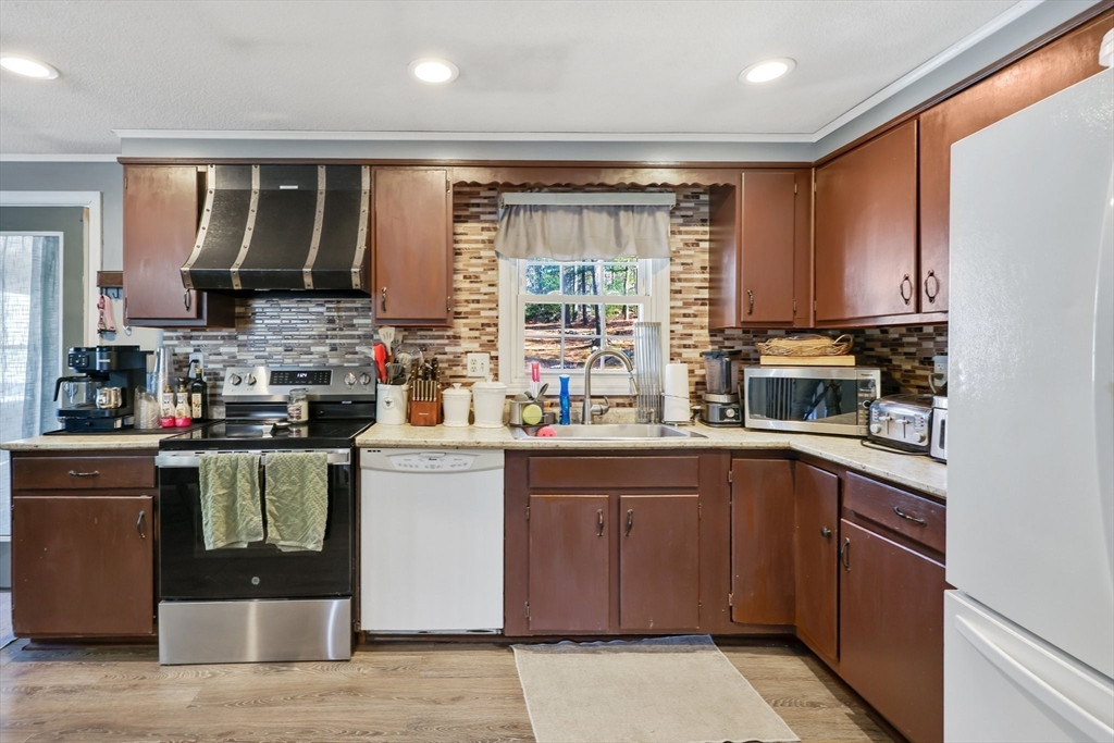 295 Burlingame Road Palmer, MA 01069 - Photo 12 of 31 a kitchen with a sink stove and cabinets