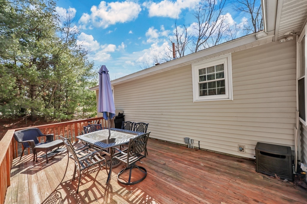295 Burlingame Road Palmer, MA 01069 - Photo 24 of 31 a view of a patio with table and chairs with wooden floor and fence