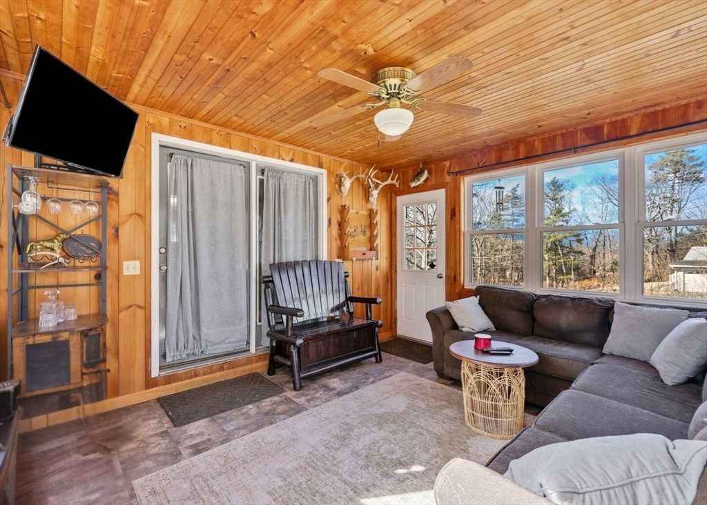 295 Burlingame Road Palmer, MA 01069 - Photo 6 of 31 a living room with furniture a flat screen tv and a large window