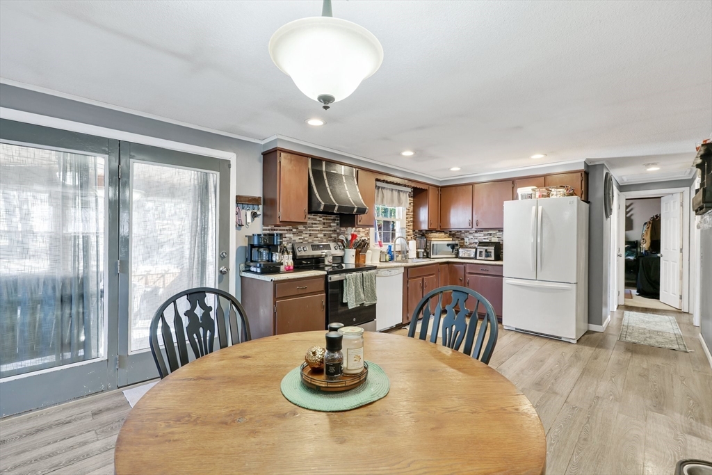 295 Burlingame Road Palmer, MA 01069 - Photo 8 of 31 a kitchen with stainless steel appliances granite countertop a table chairs and a refrigerator