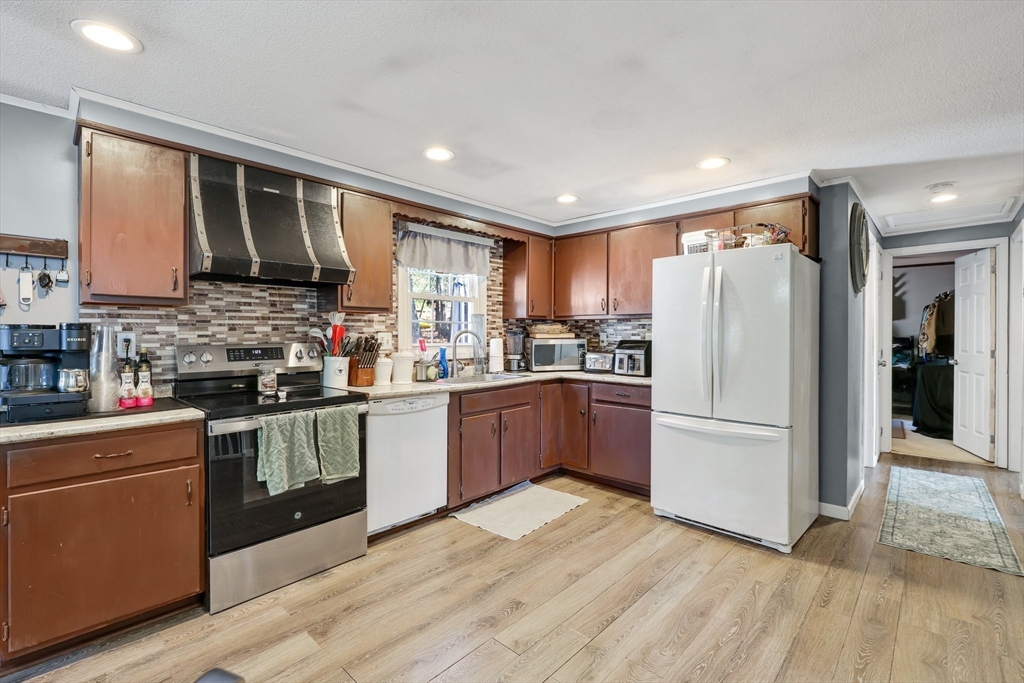 295 Burlingame Road Palmer, MA 01069 - Photo 9 of 31 a kitchen with granite countertop a refrigerator stove top oven and sink
