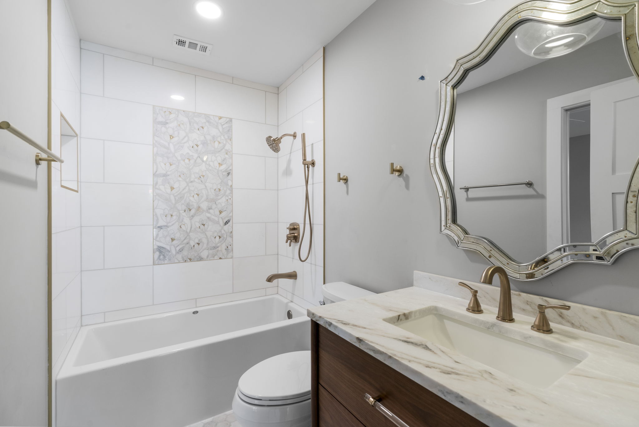 701 Furlong Drive Austin, TX 78746 - Photo 24 of 40 a bathroom with a granite countertop sink a toilet and shower