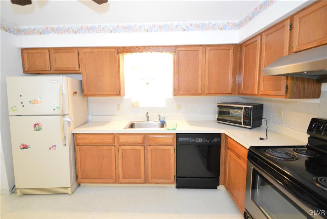 308 Mickley Road Whitehall, PA 18052 - Photo 13 of 43 a kitchen with a sink a stove and a refrigerator