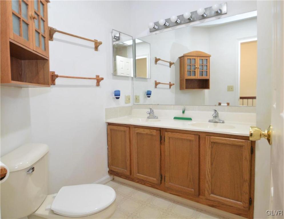 308 Mickley Road Whitehall, PA 18052 - Photo 30 of 43 a bathroom with a granite countertop toilet sink and mirror