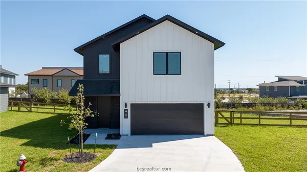 a front view of a house with a yard table and chairs