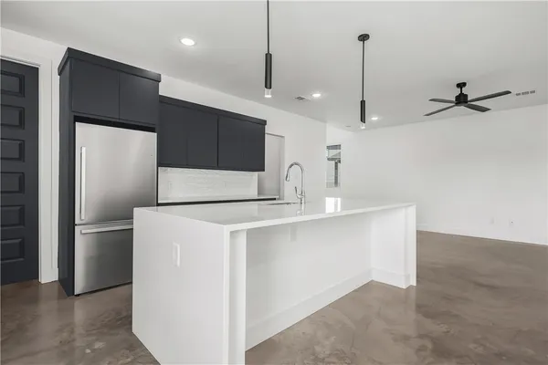 a kitchen with stainless steel appliances a refrigerator sink and microwave