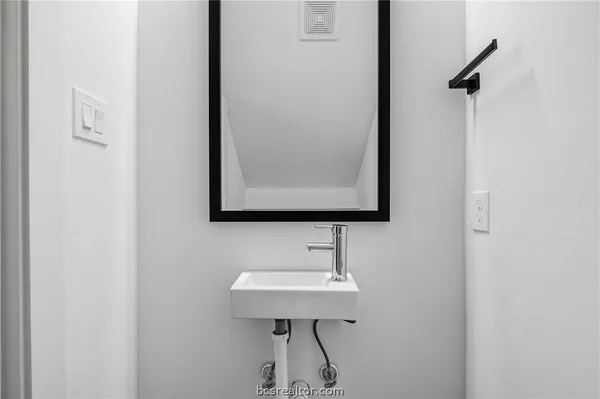 a bathroom with a sink a mirror and shower