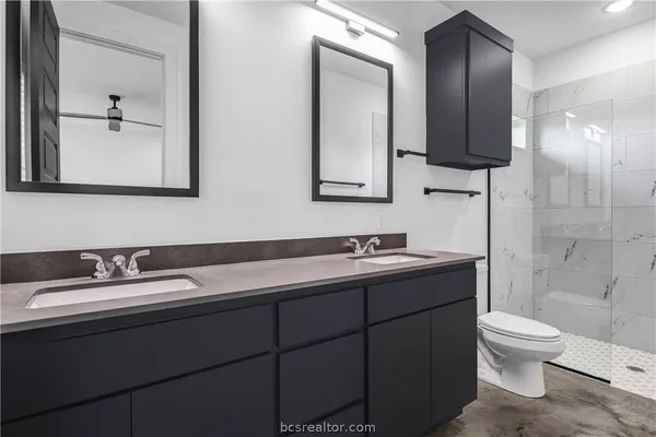 a bathroom with a toilet sink and mirror