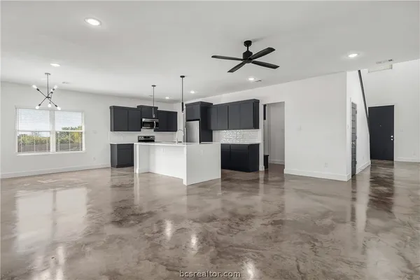 a view of a kitchen with a sink and a window