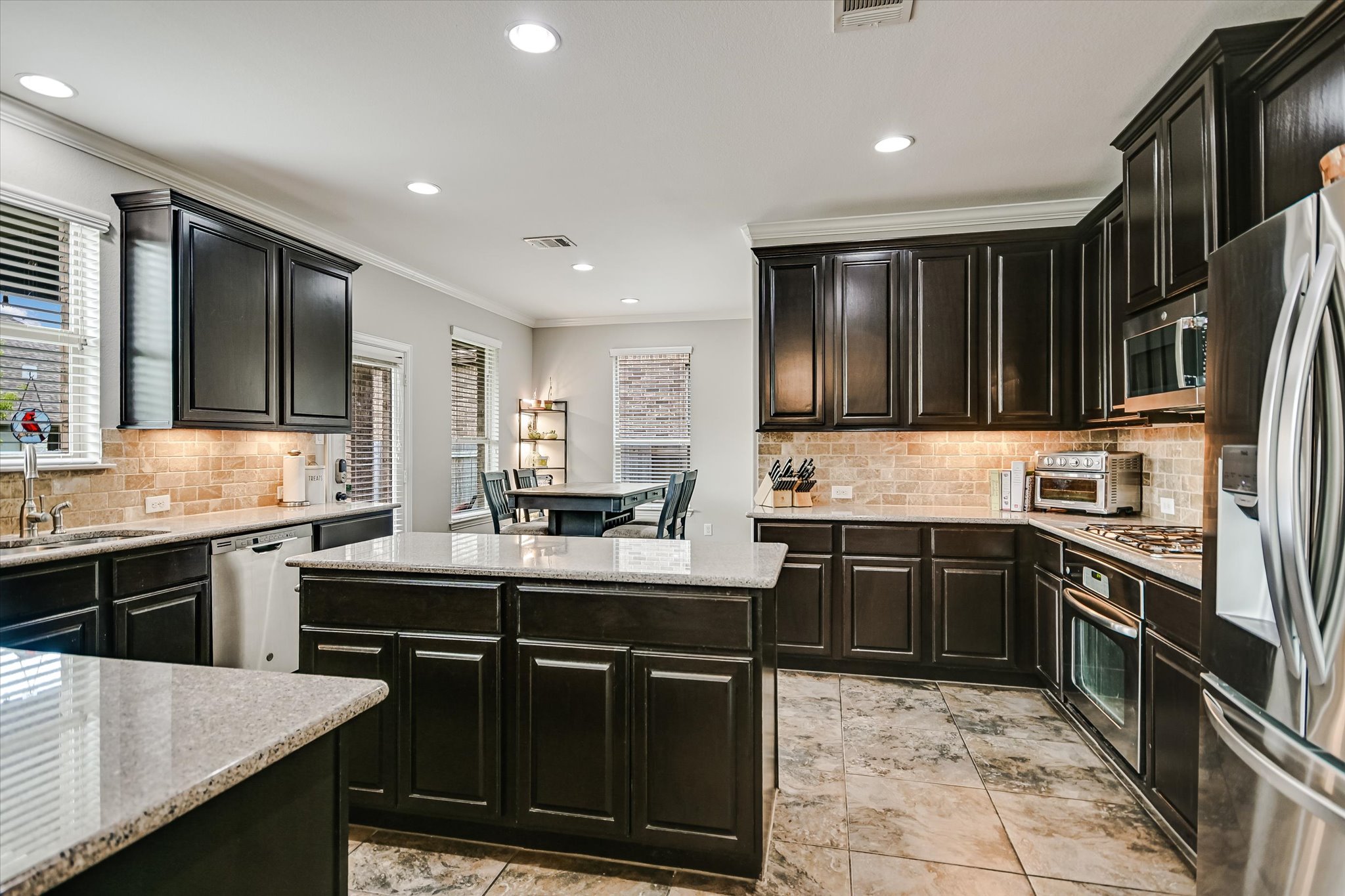 4623 Chestnut Meadows Bend Georgetown, TX 78626 - Photo 14 of 30 a kitchen with stainless steel appliances granite countertop a sink stove and refrigerator