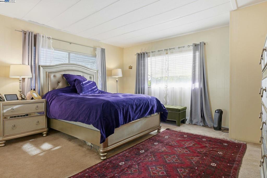 4141 Deep Creek Road Fremont, CA 94555 - Photo 26 of 54 a bedroom with a large bed and a window