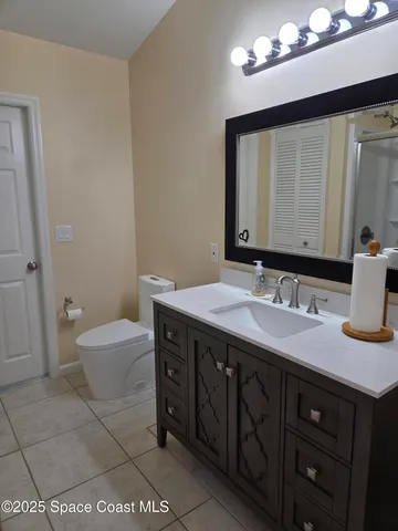 a bathroom with a double vanity sink mirror and shower