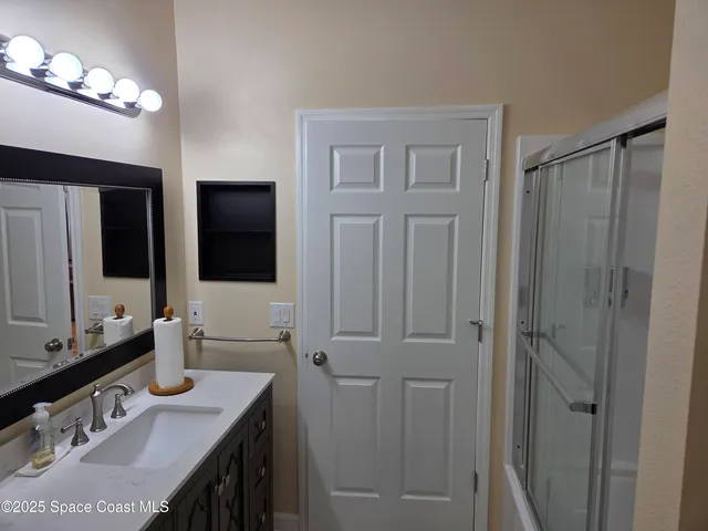 a bathroom with a double vanity sink and a mirror
