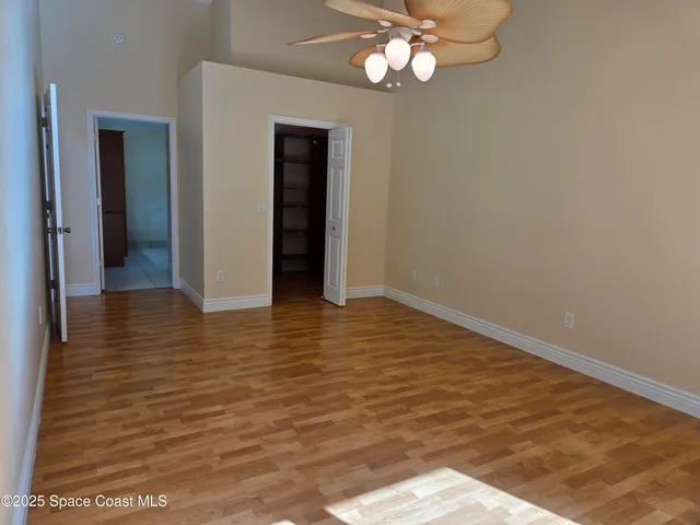 a view of a house with a small yard and flower plants