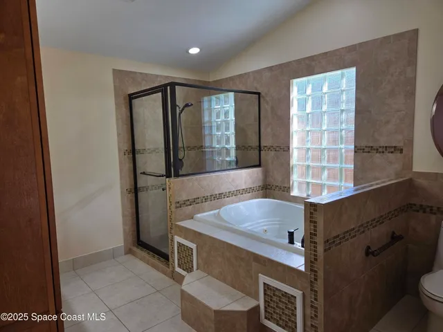 a view of a backyard with potted plants and large trees