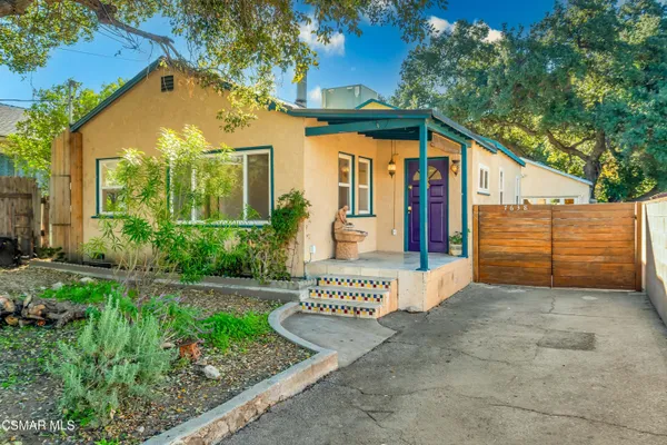 a view of a house with large windows and a yard